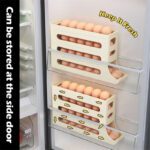 Three white egg storage racks attached to an open refrigerator door, designed to efficiently store eggs at the side door with a ‘Keep It Fresh’ label on one of them.