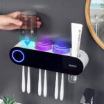 UV Sanitizer Toothbrush Holder with UV rays, mounted on a wall, featuring a sleek black design and a transparent toothbrush cup illuminated by purple UV light.