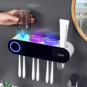 UV Sanitizer Toothbrush Holder with UV rays, mounted on a wall, featuring a sleek black design and a transparent toothbrush cup illuminated by purple UV light.